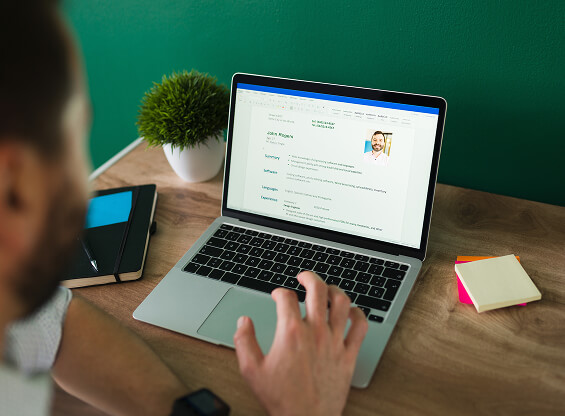 Hiring manager reviewing candidate profiles on a screen