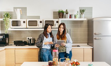 A pizza being prepared in a commercial kitchen, representing a ghost kitchen operation.